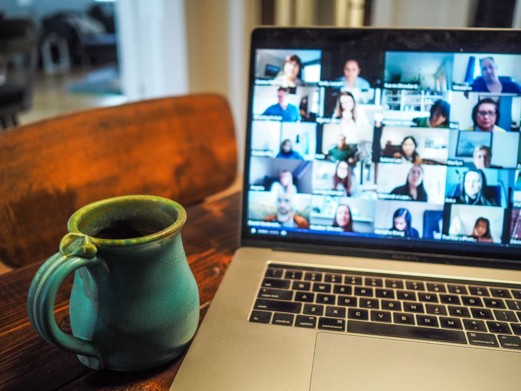 A coffee next to a computer shows the typical life of a remote working employee
